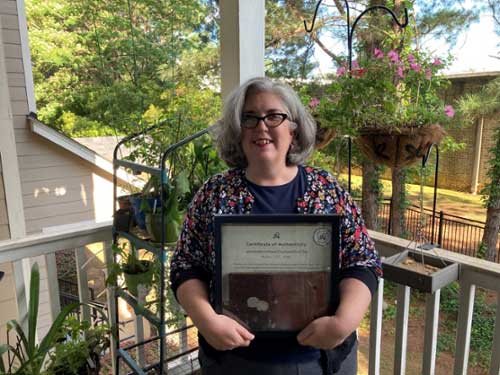 Monica Miller holds a roof tile from Jane Austen's house.